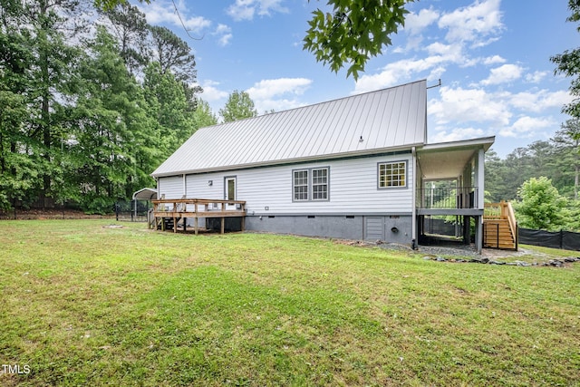 rear view of property featuring stairway, a wooden deck, crawl space, and metal roof