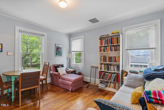 1314 Glendale Ave, Durham, NC 27701 - living area featuring plenty of natural light, wood finished floors, ornamental molding, and baseboards