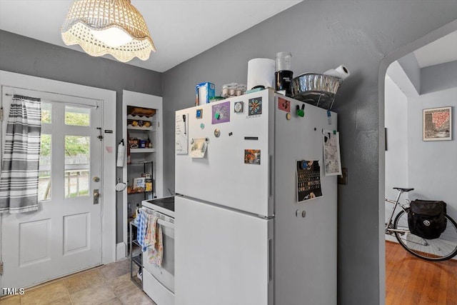1314 Glendale Ave, Durham, NC 27701 - kitchen featuring white appliances, a chandelier, and arched walkways