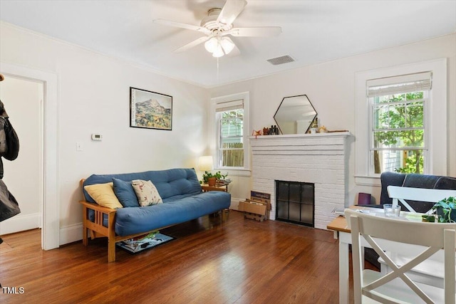 1314 Glendale Ave, Durham, NC 27701 - living area with wood finished floors, a fireplace, and a ceiling fan