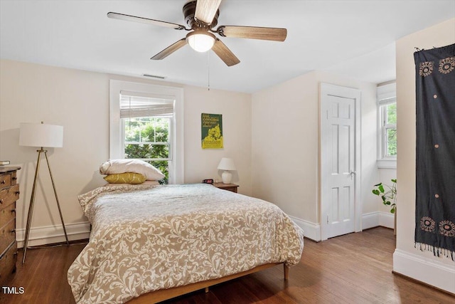 1314 Glendale Ave, Durham, NC 27701 - bedroom with multiple windows, baseboards, wood finished floors, and a ceiling fan