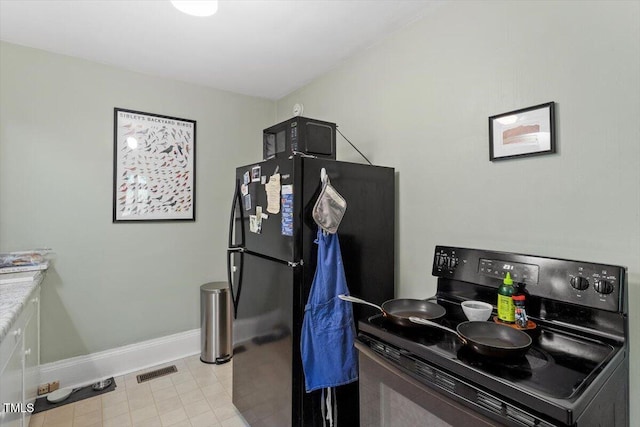 1314 Glendale Ave, Durham, NC 27701 - kitchen with black appliances and baseboards