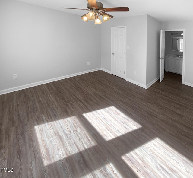 empty room featuring a ceiling fan, wood finished floors, and baseboards