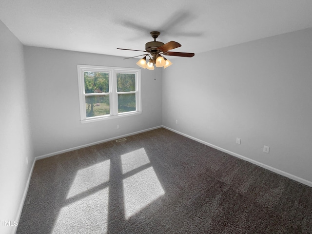 empty room featuring carpet flooring, a ceiling fan, and baseboards