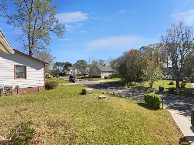 view of green lawn with a residential view