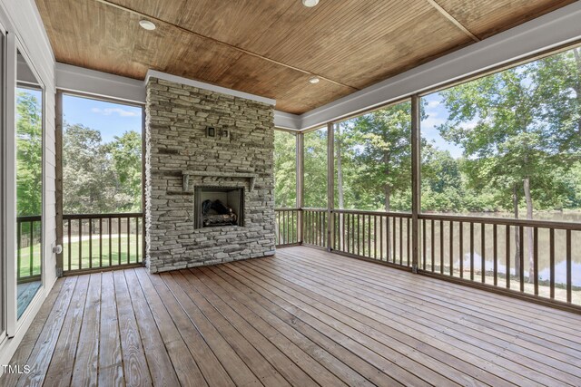 248 Ashford Dr, Pittsboro, NC 27312 - unfurnished sunroom featuring a fireplace and view of wooded area