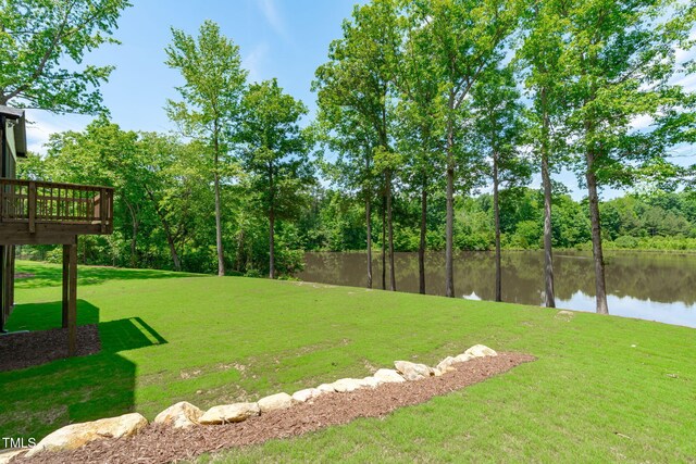 248 Ashford Dr, Pittsboro, NC 27312 - view of grassy yard featuring a deck with water view