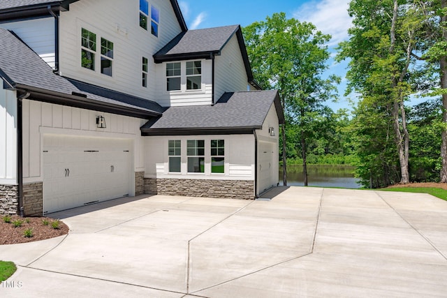 248 Ashford Dr, Pittsboro, NC 27312 - view of front of home featuring a shingled roof, concrete driveway, and stone siding