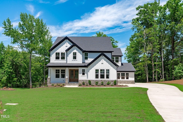 248 Ashford Dr, Pittsboro, NC 27312 - modern farmhouse style home featuring board and batten siding, french doors, concrete driveway, and a front yard