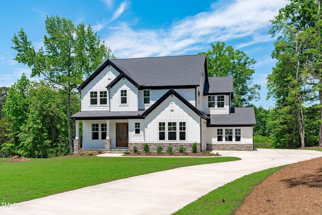 248 Ashford Dr, Pittsboro, NC 27312 - modern inspired farmhouse featuring board and batten siding, stone siding, a front yard, and roof with shingles