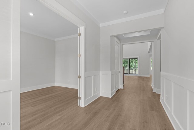 248 Ashford Dr, Pittsboro, NC 27312 - corridor featuring wood finished floors, crown molding, and a wainscoted wall
