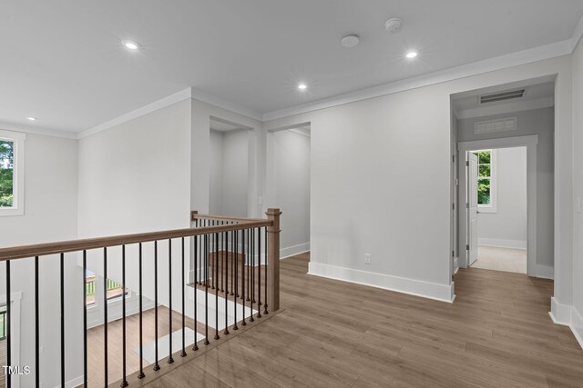 248 Ashford Dr, Pittsboro, NC 27312 - corridor featuring wood finished floors, baseboards, recessed lighting, ornamental molding, and an upstairs landing