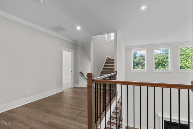 248 Ashford Dr, Pittsboro, NC 27312 - corridor featuring plenty of natural light, wood finished floors, ornamental molding, baseboards, and recessed lighting