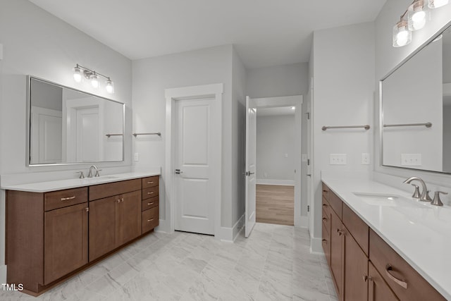 248 Ashford Dr, Pittsboro, NC 27312 - full bathroom featuring two vanities and baseboards
