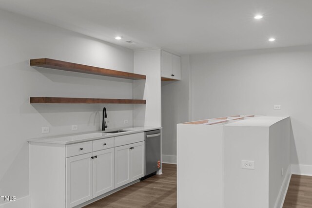 248 Ashford Dr, Pittsboro, NC 27312 - kitchen with open shelves, wood finished floors, recessed lighting, stainless steel dishwasher, and white cabinetry