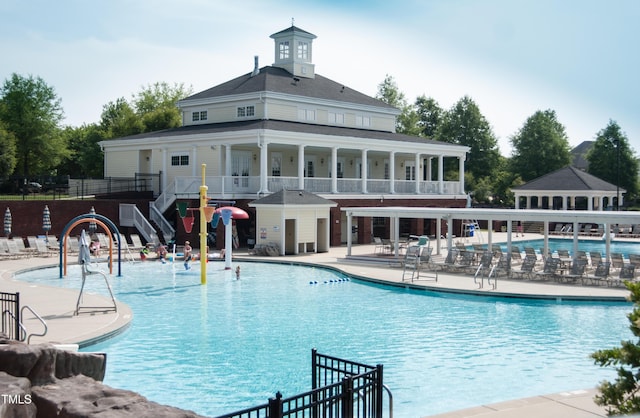 community pool with a patio and fence