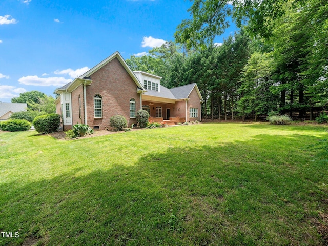 11221 Paddy Hollow Ln, Raleigh, NC 27614 - back of house featuring brick siding, a yard, and crawl space