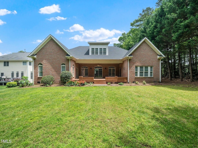 11221 Paddy Hollow Ln, Raleigh, NC 27614 - view of front facade with brick siding, a front yard, and a porch