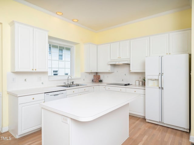 11221 Paddy Hollow Ln, Raleigh, NC 27614 - kitchen featuring white appliances, a sink, under cabinet range hood, backsplash, and white cabinets