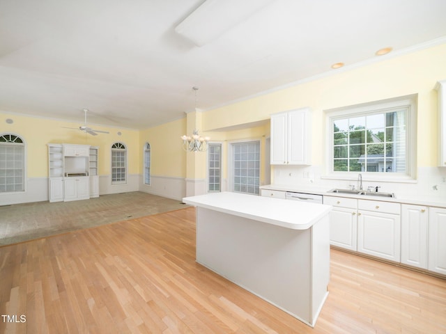 11221 Paddy Hollow Ln, Raleigh, NC 27614 - kitchen with a sink, a chandelier, light wood-style floors, light countertops, and a kitchen island