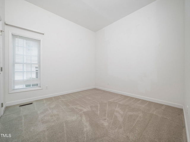 11221 Paddy Hollow Ln, Raleigh, NC 27614 - spare room featuring carpet floors, lofted ceiling, and baseboards