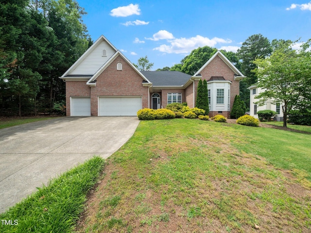 11221 Paddy Hollow Ln, Raleigh, NC 27614 - view of front of property with brick siding, an attached garage, a front yard, and driveway