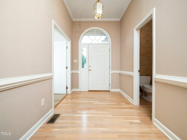 11221 Paddy Hollow Ln, Raleigh, NC 27614 - entryway with crown molding, light wood finished floors, baseboards, and a chandelier