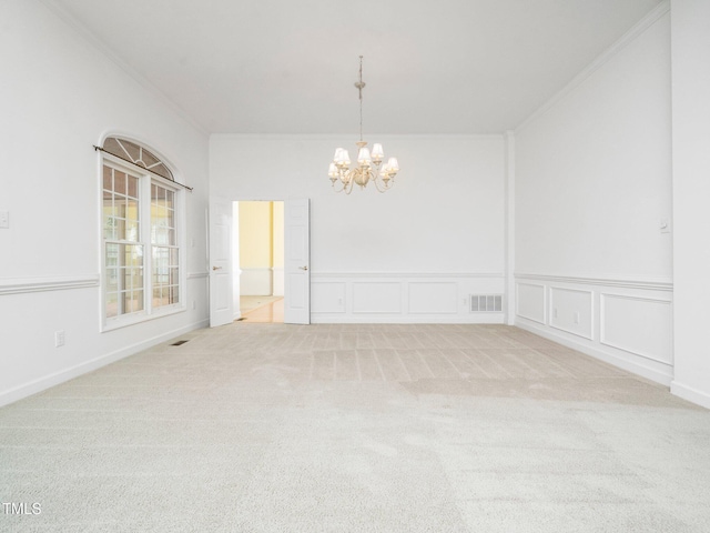 11221 Paddy Hollow Ln, Raleigh, NC 27614 - carpeted empty room featuring crown molding, a chandelier, a decorative wall, and wainscoting