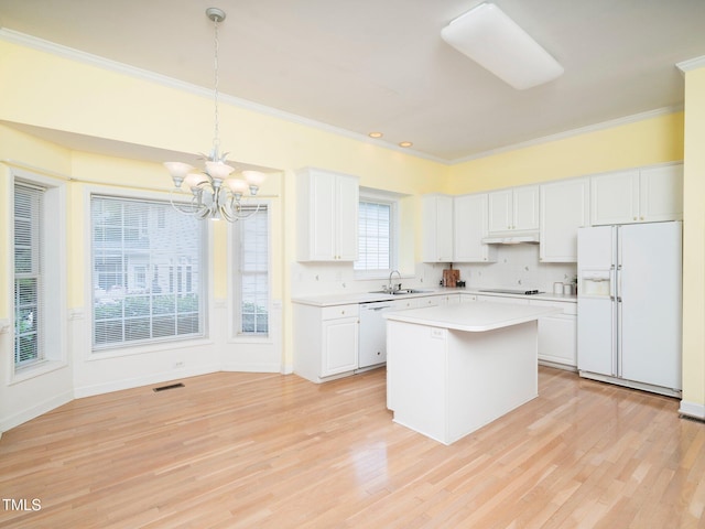 11221 Paddy Hollow Ln, Raleigh, NC 27614 - kitchen featuring white appliances, a sink, crown molding, a chandelier, and light countertops
