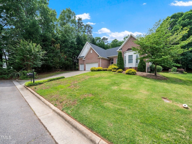 11221 Paddy Hollow Ln, Raleigh, NC 27614 - traditional home with a garage, brick siding, concrete driveway, and a front yard