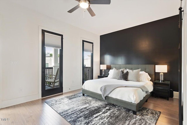bedroom with wood finished floors, baseboards, access to outside, and a ceiling fan