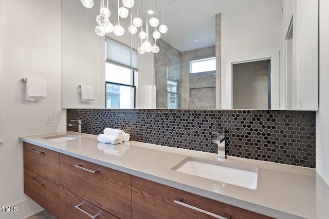 bathroom with decorative backsplash, a walk in shower, and double vanity