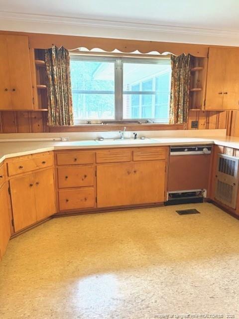 209 S Main St, Salemburg, NC 28385 - kitchen with open shelves, dishwashing machine, ornamental molding, and light countertops