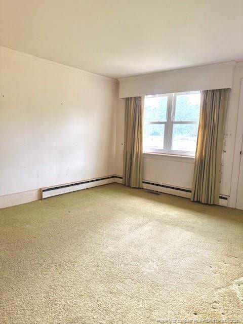 209 S Main St, Salemburg, NC 28385 - spare room featuring a baseboard heating unit and light carpet