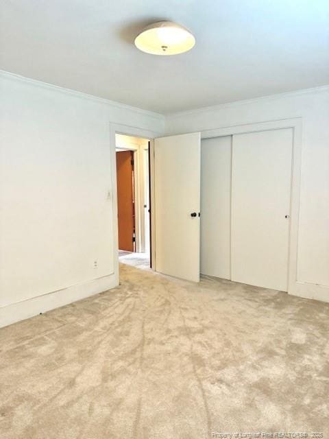 209 S Main St, Salemburg, NC 28385 - unfurnished bedroom with crown molding, a closet, and light carpet