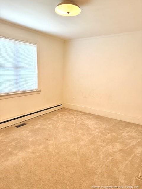 209 S Main St, Salemburg, NC 28385 - carpeted empty room with ornamental molding, baseboard heating, and baseboards