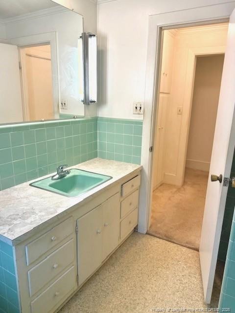 209 S Main St, Salemburg, NC 28385 - bathroom featuring crown molding and vanity
