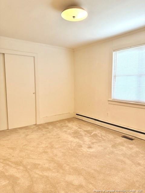 209 S Main St, Salemburg, NC 28385 - spare room with a baseboard radiator, crown molding, and light colored carpet