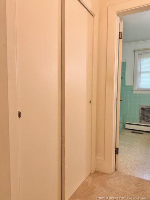 209 S Main St, Salemburg, NC 28385 - corridor with carpet floors, tile walls, a wainscoted wall, and baseboard heating