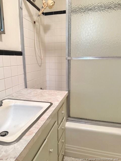 209 S Main St, Salemburg, NC 28385 - full bath with shower / bath combination with glass door, vanity, and tile walls
