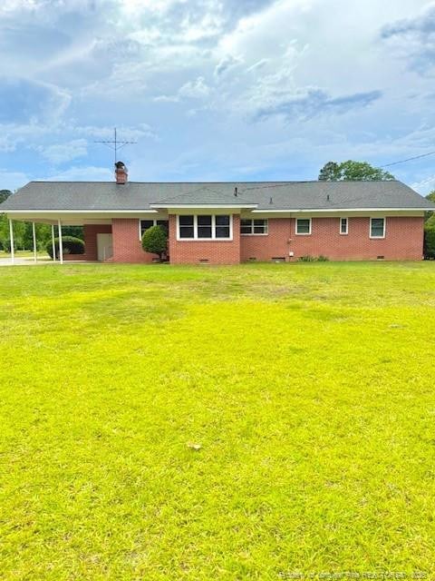 209 S Main St, Salemburg, NC 28385 - back of property with a lawn and a chimney
