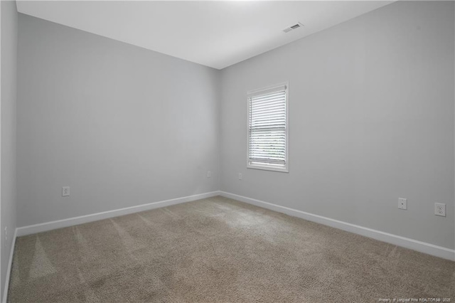 unfurnished room with light carpet and baseboards