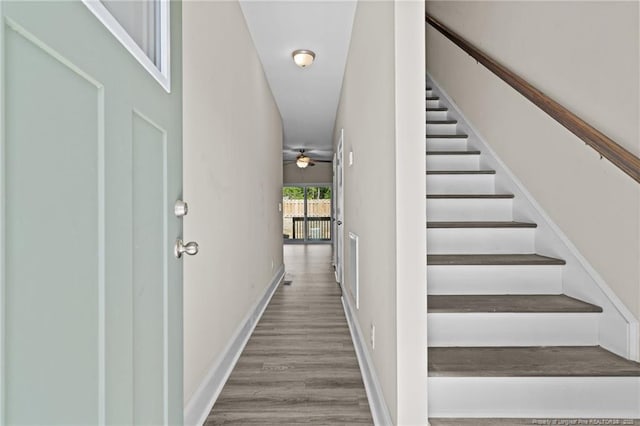 stairway featuring wood finished floors and baseboards
