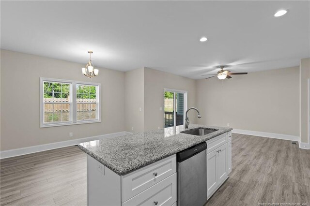 kitchen with a sink, stainless steel dishwasher, healthy amount of natural light, white cabinetry, and recessed lighting