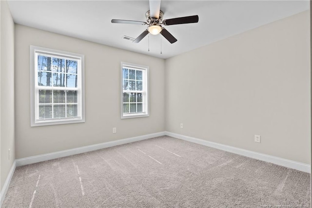 spare room with baseboards, carpet, and a ceiling fan