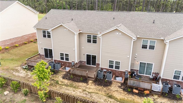 rear view of property featuring a deck and central air condition unit