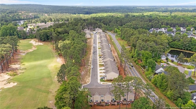 aerial overview of property's location featuring a heavily wooded area, a local golf course, and a nearby body of water