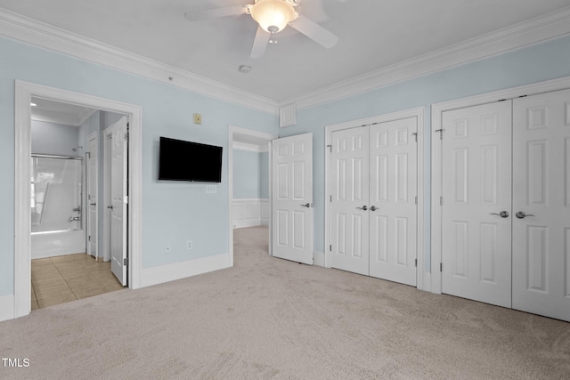 735 Portstewart Dr, Cary, NC 27519 - unfurnished bedroom with carpet flooring, crown molding, two closets, ensuite bathroom, and a ceiling fan