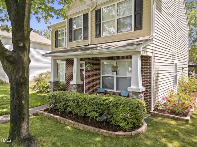 view of front of home with brick siding and a front lawn