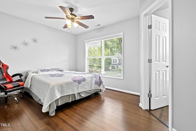 bedroom with baseboards, wood finished floors, and a ceiling fan